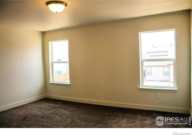 8710 8th St, Greeley, CO 80634 - empty room with dark colored carpet and baseboards