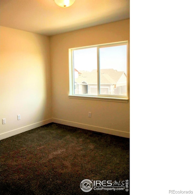 8710 8th St, Greeley, CO 80634 - spare room with baseboards and dark carpet