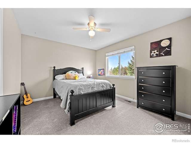bedroom with carpet floors, baseboards, ceiling fan, and visible vents