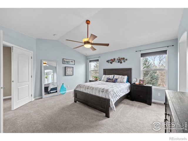 bedroom featuring baseboards, a ceiling fan, vaulted ceiling, and light carpet