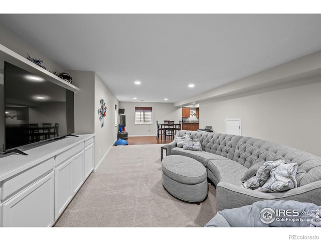 living room featuring carpet floors, recessed lighting, and baseboards