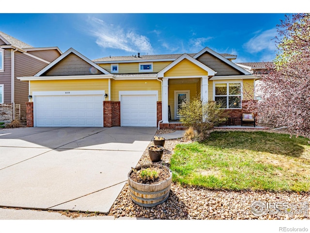 view of front of home with a front lawn, brick siding, concrete driveway, an attached garage, and a porch