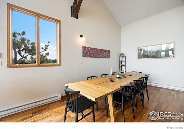 810 Manhead Mountain Dr, Livermore, CO 80536 - dining area with a baseboard radiator, high vaulted ceiling, and wood finished floors