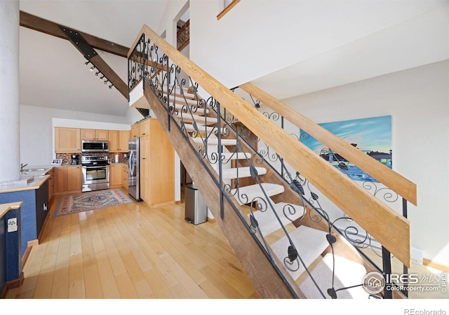 810 Manhead Mountain Dr, Livermore, CO 80536 - stairs with hardwood / wood-style flooring and a towering ceiling
