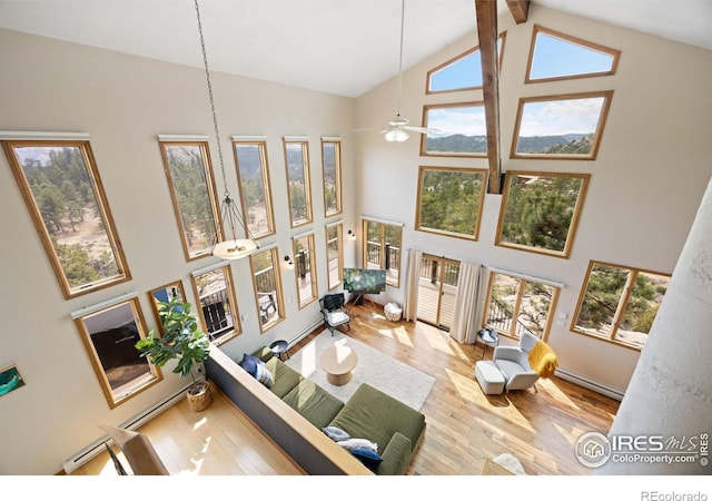 810 Manhead Mountain Dr, Livermore, CO 80536 - living area with high vaulted ceiling, wood finished floors, ceiling fan, a baseboard heating unit, and beam ceiling