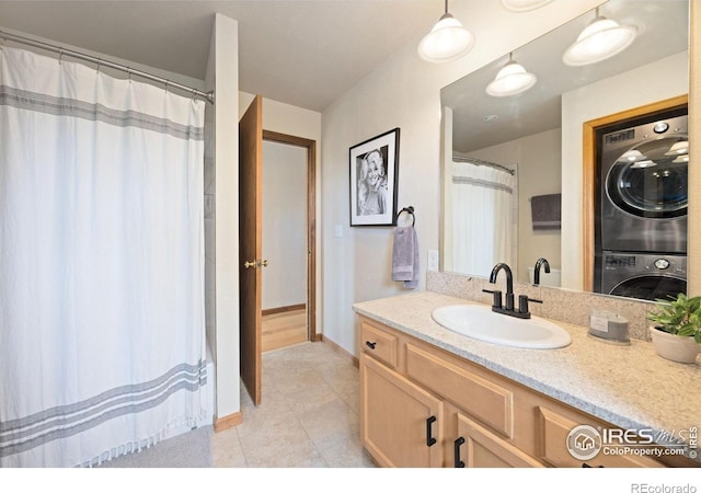 810 Manhead Mountain Dr, Livermore, CO 80536 - full bathroom with estacked washer and dryer, vanity, tile patterned flooring, baseboards, and a shower with shower curtain