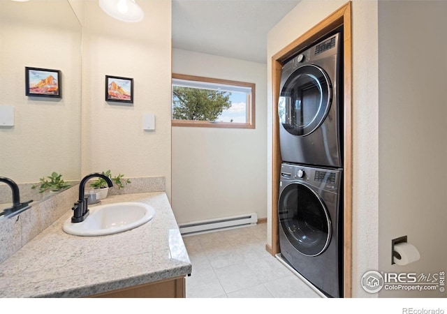 810 Manhead Mountain Dr, Livermore, CO 80536 - laundry area featuring baseboard heating, a sink, stacked washing machine and dryer, and light tile patterned floors