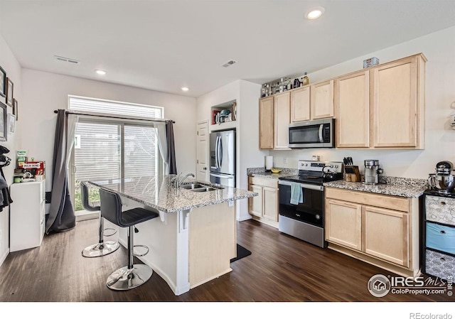 3506 Valleywood Ct, Johnstown, CO 80534 - kitchen featuring dark wood-style floors, stainless steel appliances, visible vents, light brown cabinets, and a sink