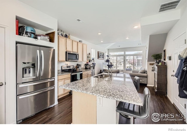 3506 Valleywood Ct, Johnstown, CO 80534 - kitchen with visible vents, light brown cabinets, stainless steel appliances, and dark wood-style floors