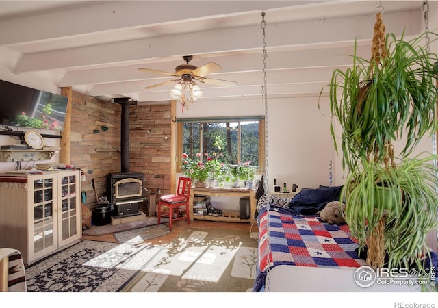 147 Cedar Dr, Lyons, CO 80540 - bedroom with a wood stove and beamed ceiling