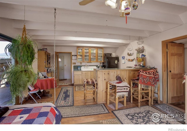 147 Cedar Dr, Lyons, CO 80540 - bar featuring light wood finished floors, freestanding refrigerator, and beam ceiling