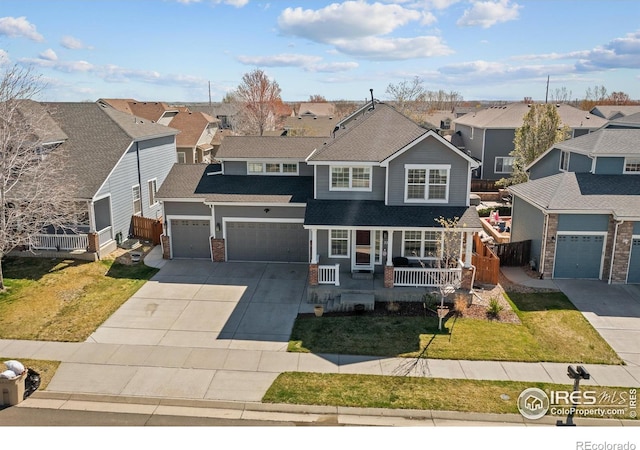 338 Mt Wilson St, Brighton, CO 80601 - traditional home with covered porch, a residential view, driveway, and an attached garage