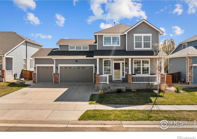 338 Mt Wilson St, Brighton, CO 80601 - view of front of house featuring covered porch, driveway, a garage, brick siding, and roof with shingles