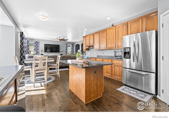 338 Mt Wilson St, Brighton, CO 80601 - kitchen with stainless steel fridge with ice dispenser, dark wood-style floors, a ceiling fan, brown cabinetry, and open floor plan