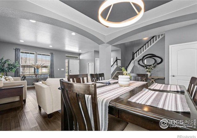 338 Mt Wilson St, Brighton, CO 80601 - dining room featuring stairs, arched walkways, recessed lighting, and dark wood finished floors