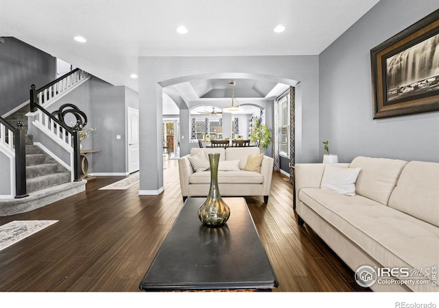 338 Mt Wilson St, Brighton, CO 80601 - living area featuring wood finished floors, arched walkways, recessed lighting, stairway, and a raised ceiling