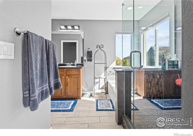 338 Mt Wilson St, Brighton, CO 80601 - full bathroom featuring vanity, a garden tub, a shower stall, wood finish floors, and recessed lighting