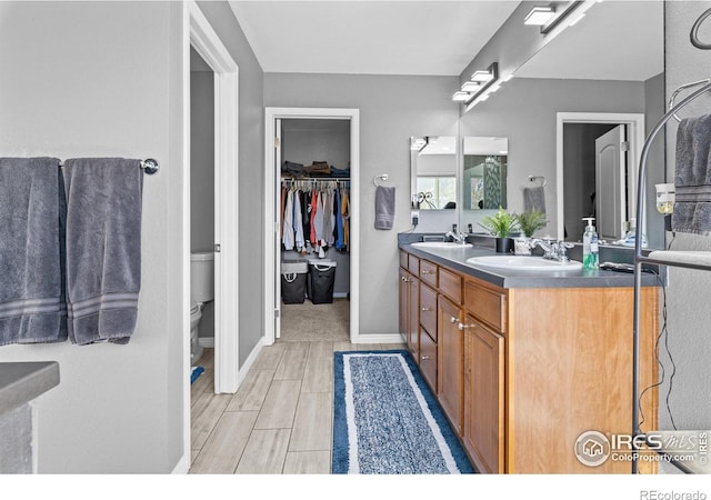 338 Mt Wilson St, Brighton, CO 80601 - bathroom featuring double vanity and a walk in closet