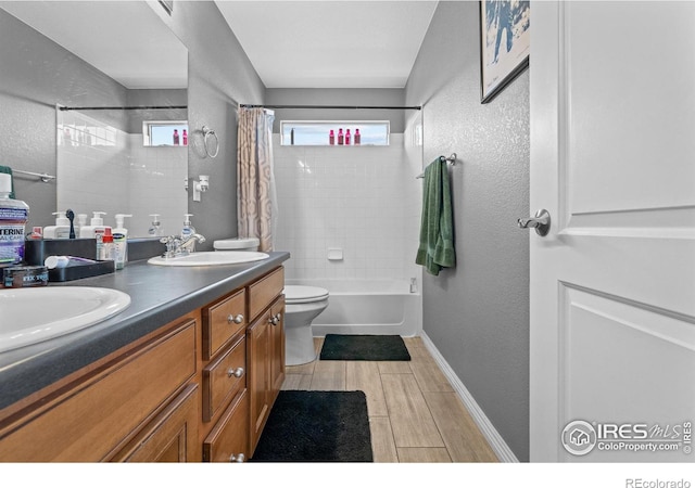 338 Mt Wilson St, Brighton, CO 80601 - bathroom featuring double vanity, shower / bath combo with shower curtain, a textured wall, and wood finished floors