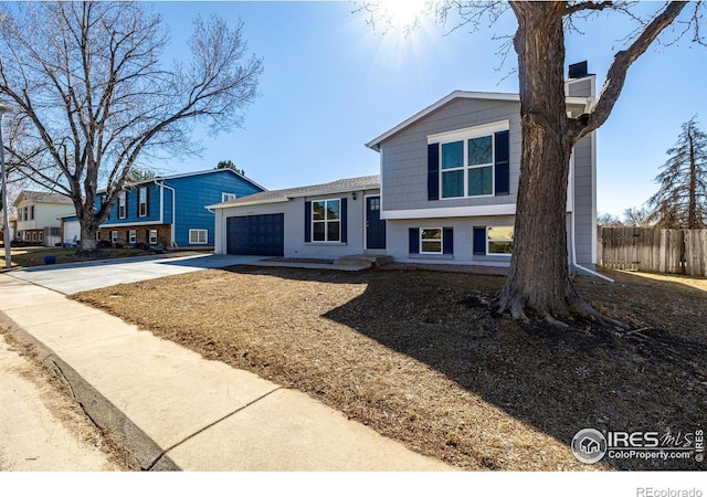 4752 E 108th Pl, Thornton, CO 80233 - split level home featuring fence, driveway, brick siding, and a garage