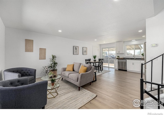 4752 E 108th Pl, Thornton, CO 80233 - living area featuring a textured ceiling, light wood finished floors, and recessed lighting