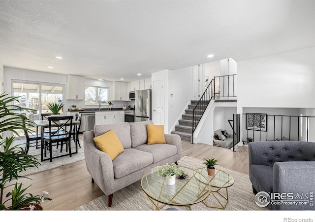 4752 E 108th Pl, Thornton, CO 80233 - living area featuring recessed lighting, light wood-style flooring, and stairs