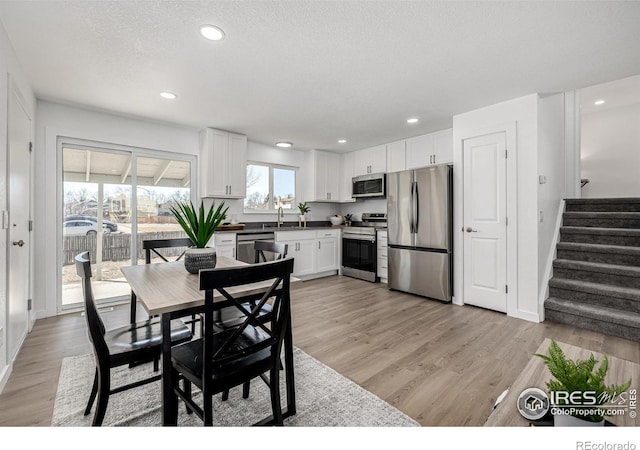 4752 E 108th Pl, Thornton, CO 80233 - dining area featuring stairway, light wood-style floors, and recessed lighting