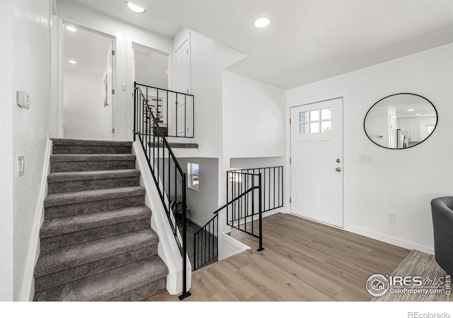 4752 E 108th Pl, Thornton, CO 80233 - entrance foyer with baseboards, wood finished floors, recessed lighting, and stairs