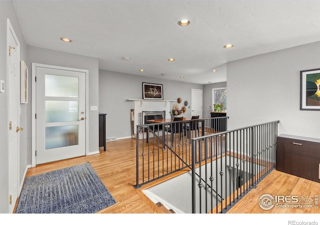 1247 Westview Dr, Boulder, CO 80303 - hallway with baseboards, recessed lighting, wood finished floors, and an upstairs landing
