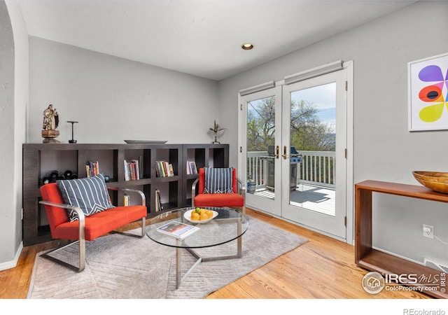 1247 Westview Dr, Boulder, CO 80303 - sitting room with baseboards, arched walkways, french doors, and wood finished floors