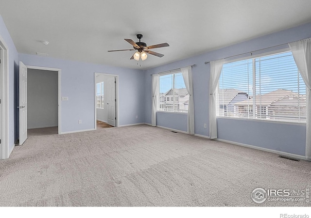interior space featuring visible vents, baseboards, carpet, and ceiling fan