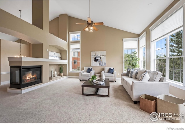 3122 Notabon Ct, Lafayette, CO 80026 - carpeted living area featuring plenty of natural light, a multi sided fireplace, and ceiling fan