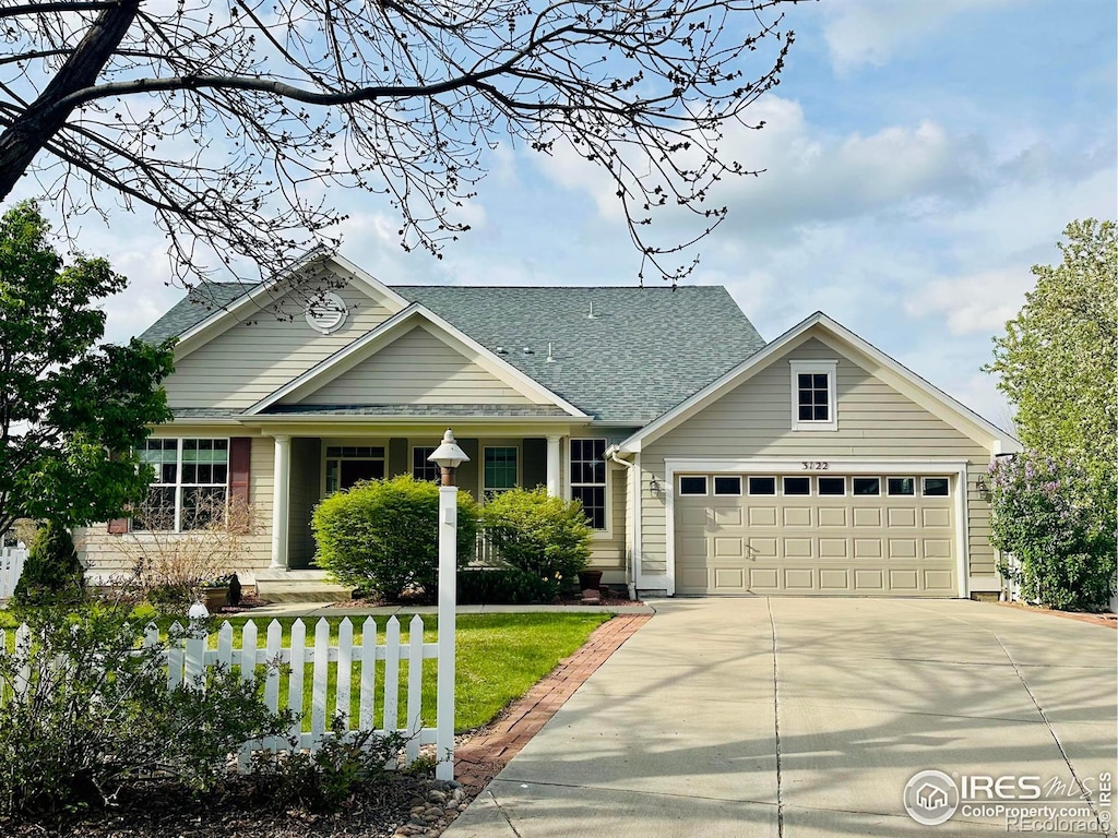 3122 Notabon Ct, Lafayette, CO 80026 - view of front of home with a garage, concrete driveway, a front lawn, and a shingled roof