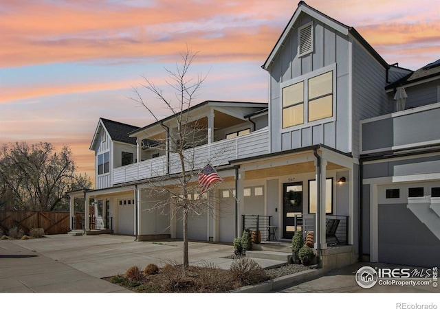 267 Clementina St, Louisville, CO 80027 - view of front facade with board and batten siding, covered porch, an attached garage, and a balcony