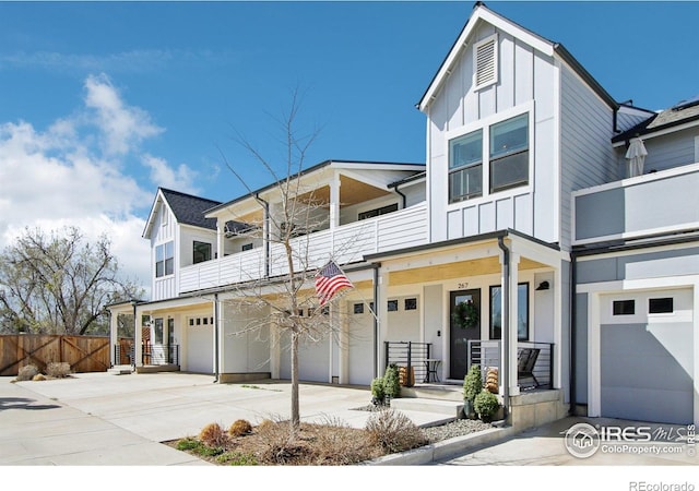 267 Clementina St, Louisville, CO 80027 - view of front of home with a porch, fence, a garage, a balcony, and board and batten siding