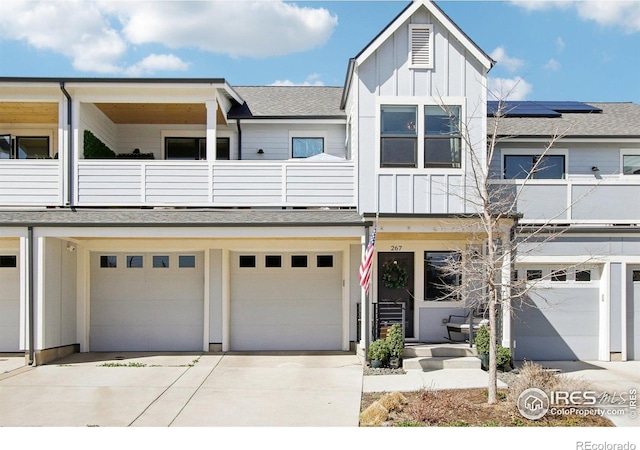 267 Clementina St, Louisville, CO 80027 - view of property with roof with shingles, driveway, a garage, a balcony, and board and batten siding