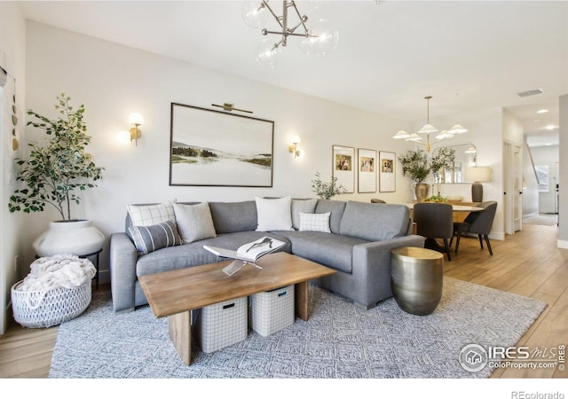 267 Clementina St, Louisville, CO 80027 - living room featuring a notable chandelier, visible vents, and light wood-type flooring