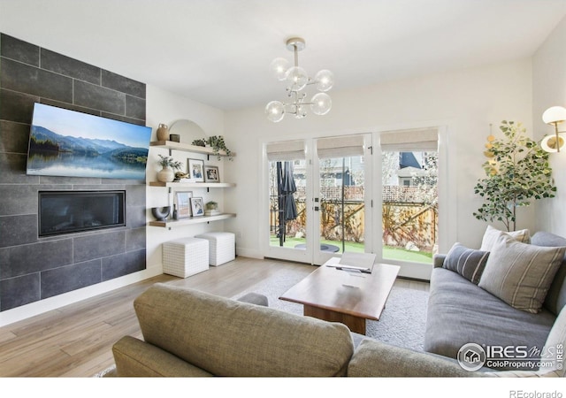 267 Clementina St, Louisville, CO 80027 - living area with baseboards, a tile fireplace, wood finished floors, and a chandelier