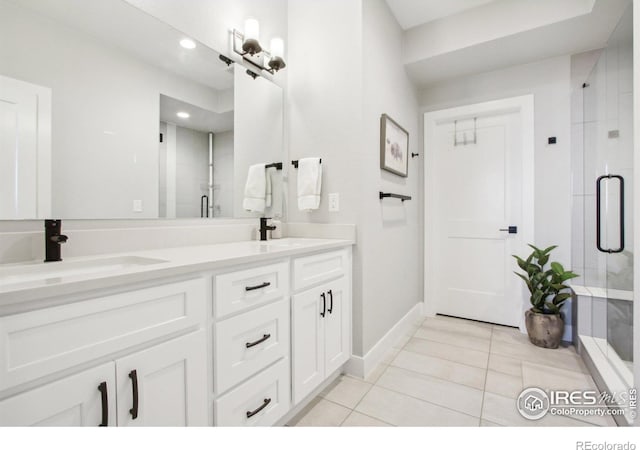 267 Clementina St, Louisville, CO 80027 - full bathroom featuring double vanity, tile patterned flooring, a stall shower, and a sink