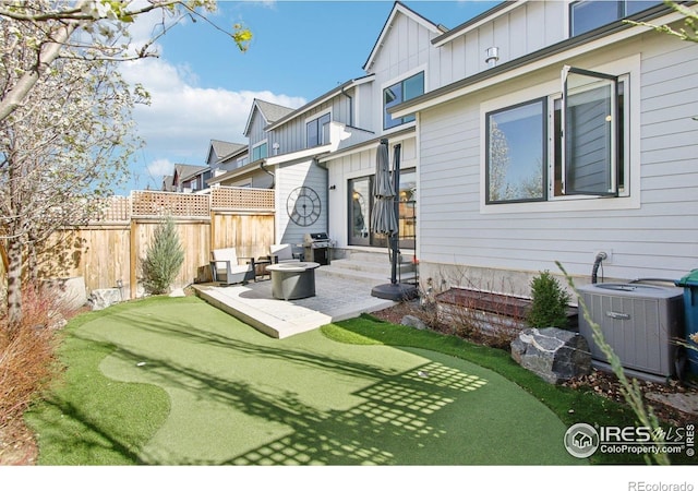 267 Clementina St, Louisville, CO 80027 - back of property featuring board and batten siding, a patio area, fence, and central AC