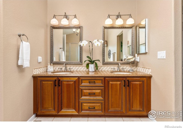 full bath featuring tile patterned flooring, decorative backsplash, a sink, and double vanity