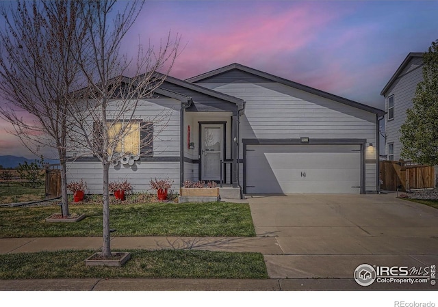 6021 Sandstone Cir, Erie, CO 80516 - ranch-style house with concrete driveway, an attached garage, fence, and a front lawn