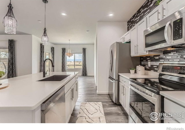 6021 Sandstone Cir, Erie, CO 80516 - kitchen featuring a sink, decorative backsplash, light countertops, appliances with stainless steel finishes, and recessed lighting