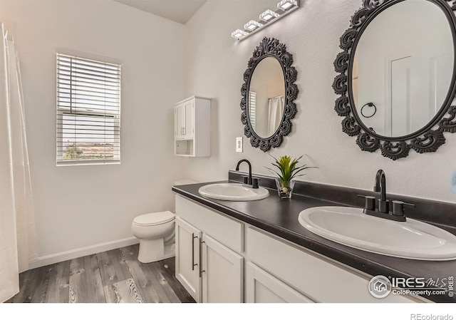 6021 Sandstone Cir, Erie, CO 80516 - bathroom featuring baseboards, wood finished floors, a sink, and toilet