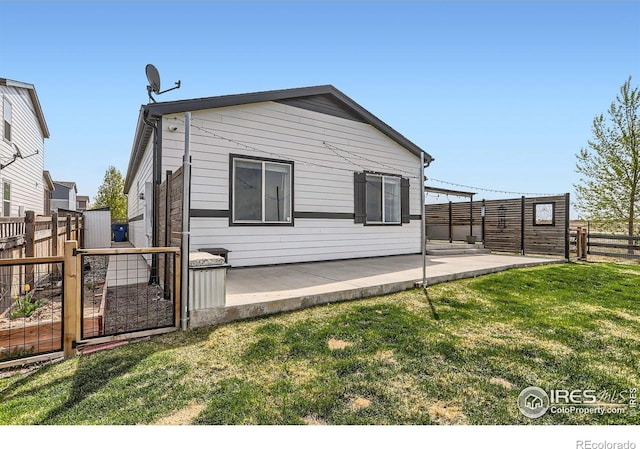 6021 Sandstone Cir, Erie, CO 80516 - rear view of property with a gate, a yard, a patio area, and a fenced backyard