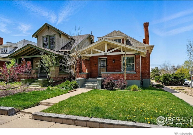 craftsman inspired home with a front lawn, covered porch, brick siding, and a chimney