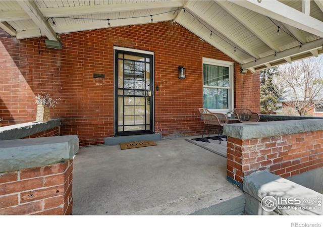 3059 N York St, Denver, CO 80205 - property entrance featuring a porch and brick siding