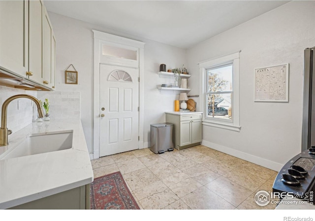 3059 N York St, Denver, CO 80205 - laundry room featuring cabinet space, light tile patterned floors, baseboards, and a sink