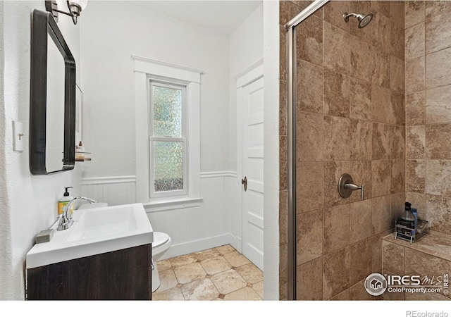 3059 N York St, Denver, CO 80205 - bathroom featuring vanity, toilet, a wainscoted wall, and a stall shower