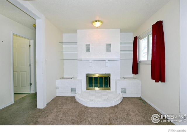 unfurnished living room featuring visible vents, a brick fireplace, and carpet flooring